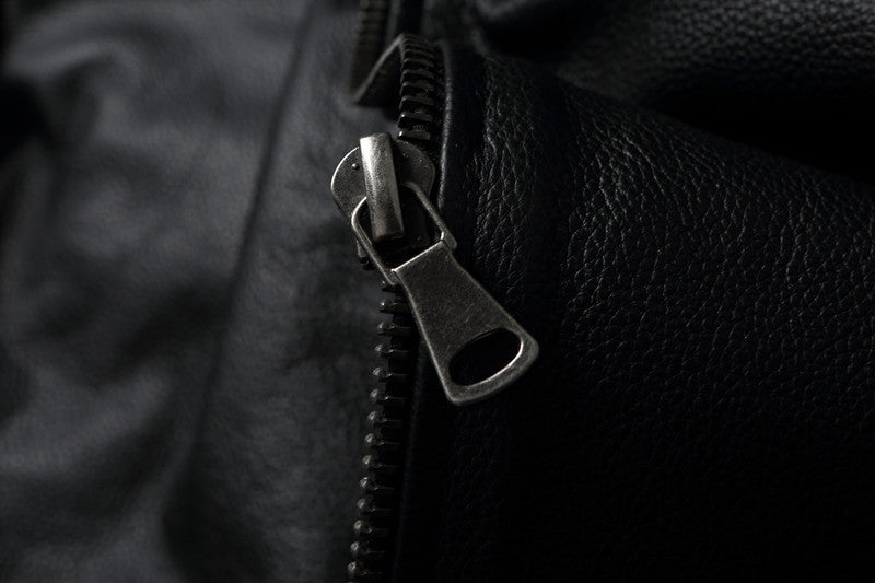 Close-up of a zipper on black leather texture
