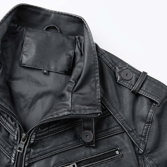 Close-up of a black leather jacket with visible stitching and buttons on a white background