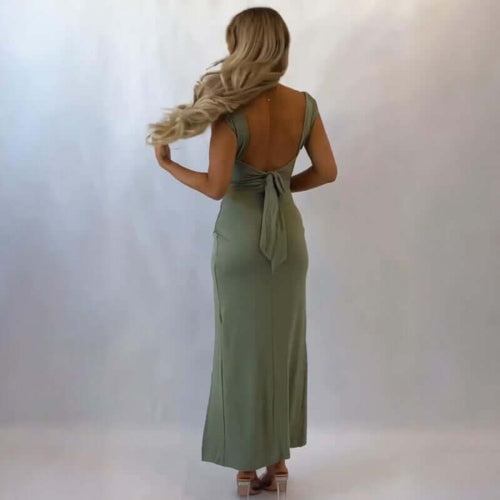 Woman wearing a green Square Neck Maxi Dress with a backless design on a white background