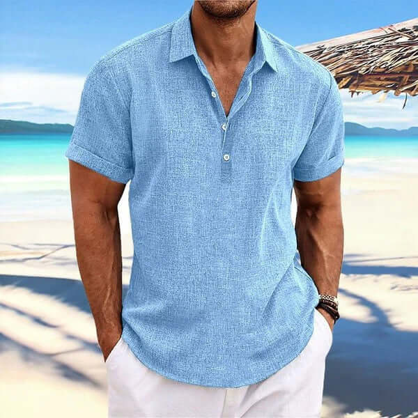 Business Casual Men Cardigan Shirt in a blue color, perfect for a smart-casual look by the beach.
