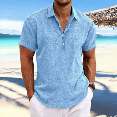 Business Casual Men Cardigan Shirt in a blue color, perfect for a smart-casual look by the beach.