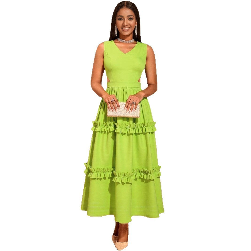 Woman wearing a bright green dress with ruffled layers on a white background