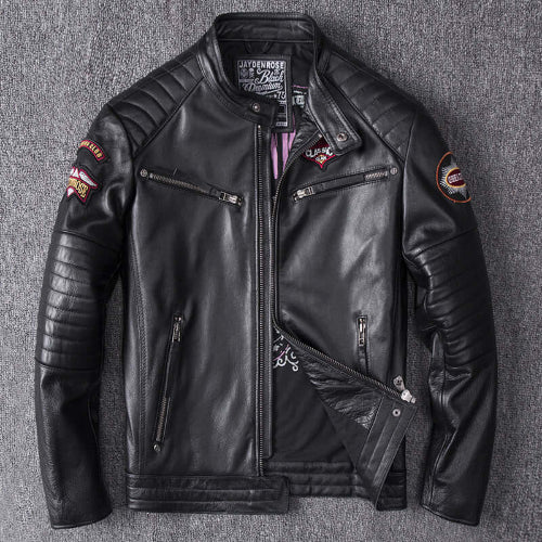 Black leather jacket with patches on a gray textured background