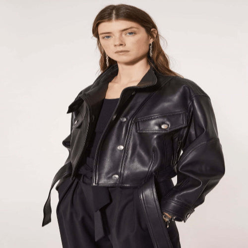 Woman wearing a black leather jacket on a white background