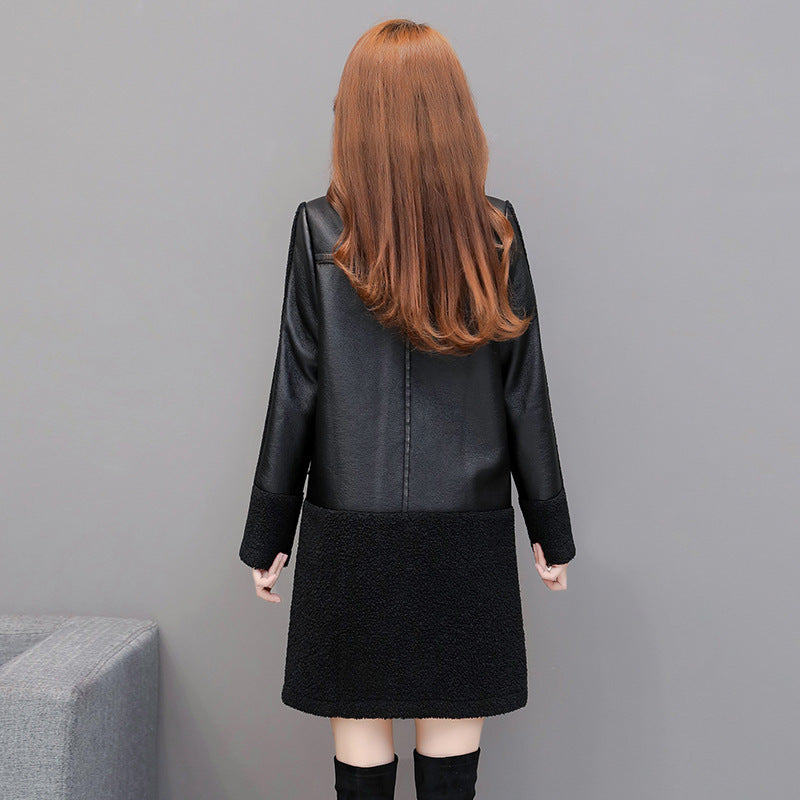 Person wearing a black leather jacket and skirt set against a gray background