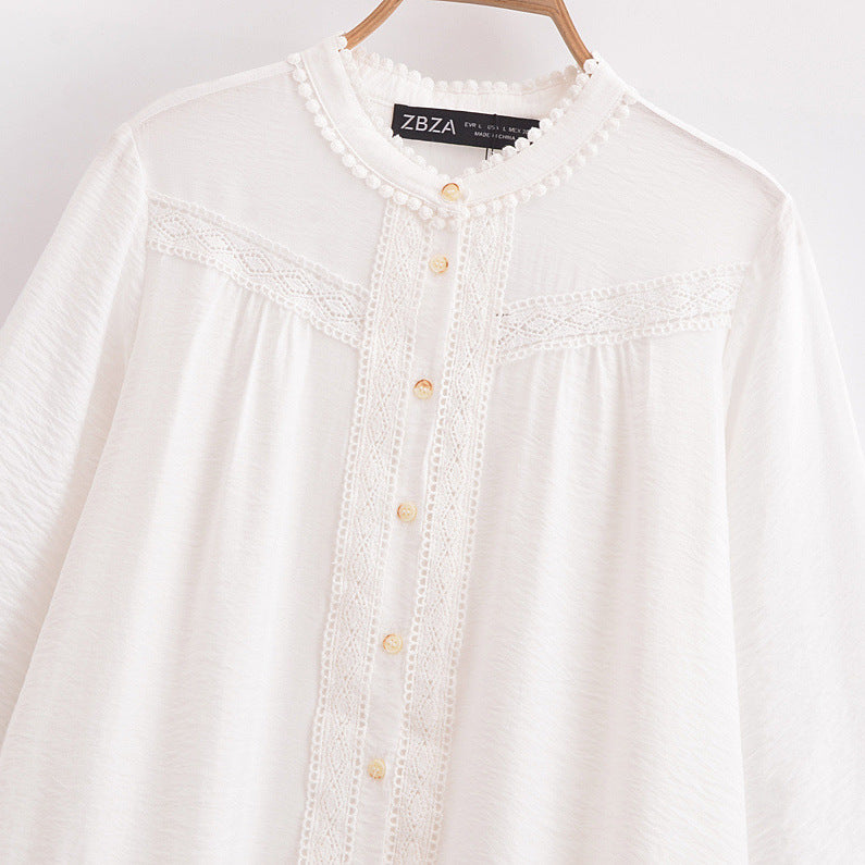 White blouse with lace details and button accents on a hanger, featuring the brand 'ZBZA'.