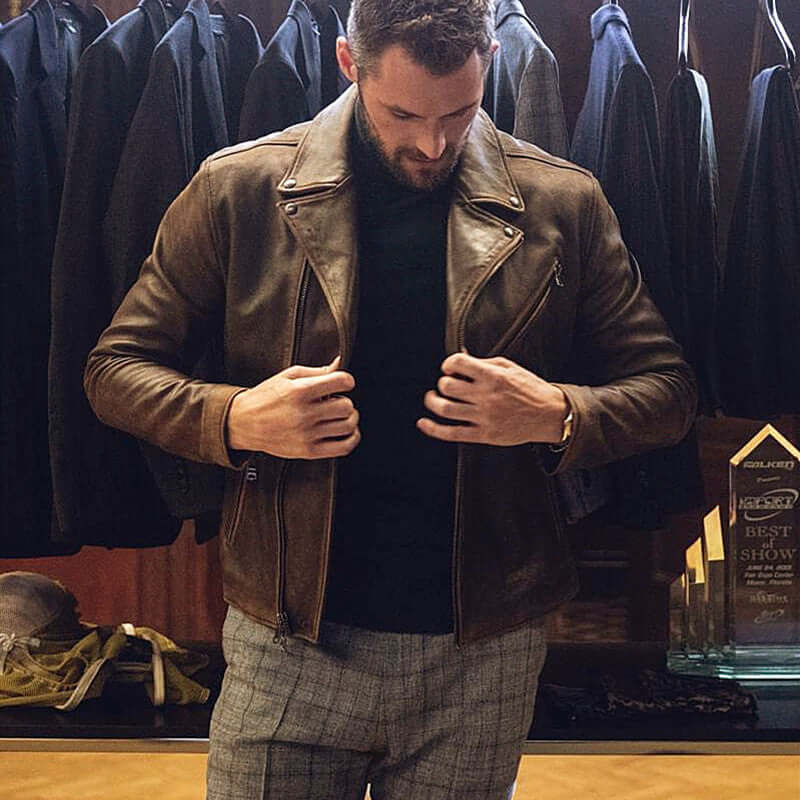 Man wearing a brown leather jacket in a clothing store.